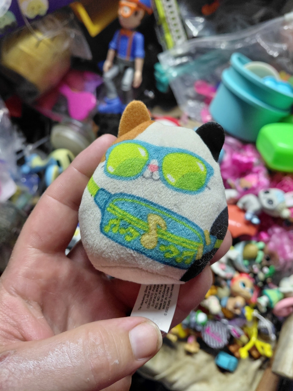Squishmallows Calico Cat Toy with Green Sunglasses and Turquoise Fanny Pack